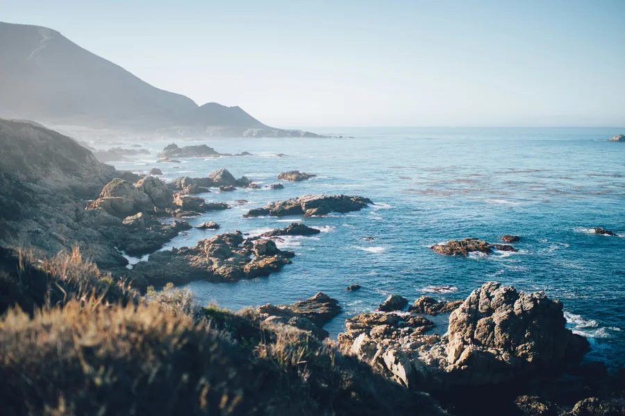 A rocky coastline in morning haze, as shot, before developing in Focal